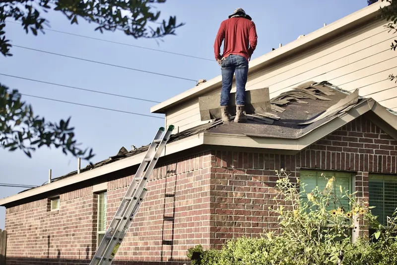 Professional roofer working on a residential roof in Blue Goose